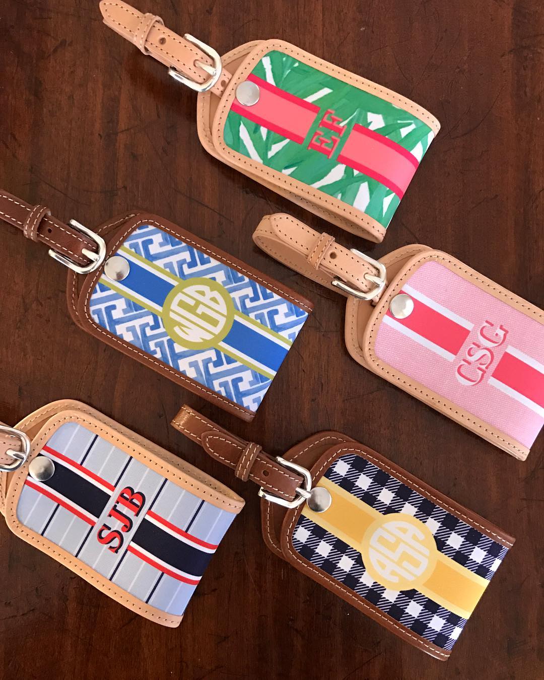 Stylish woman with custom leather luggage tag on plaid tote bag